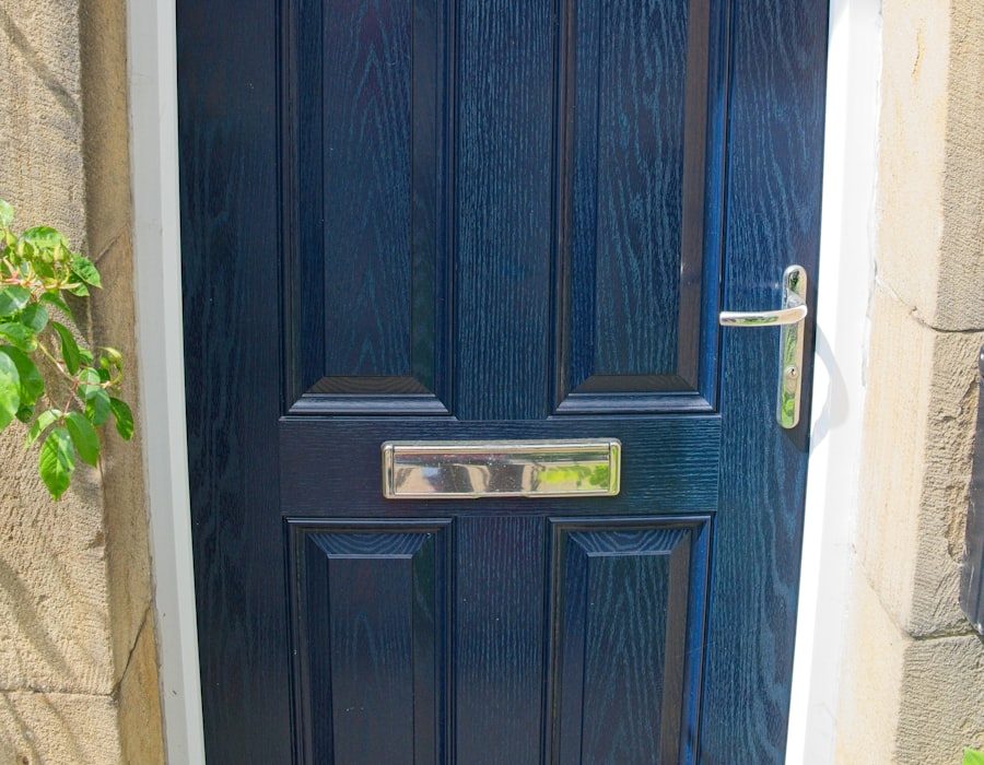 Navy blue composite front door with moulded panels and chrome letterplate