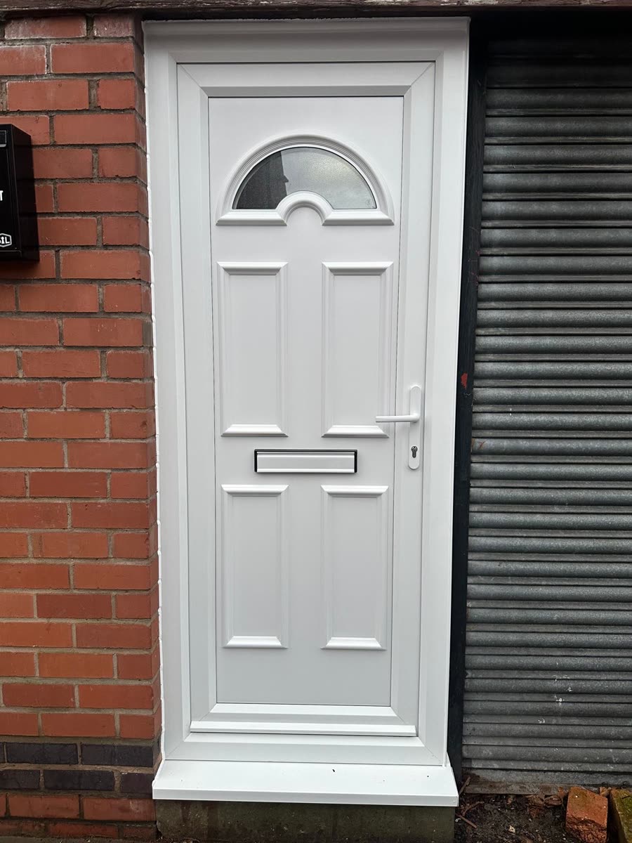 A white uPVC panel front door with an arched top light and chrome letterplate, fitted by URG