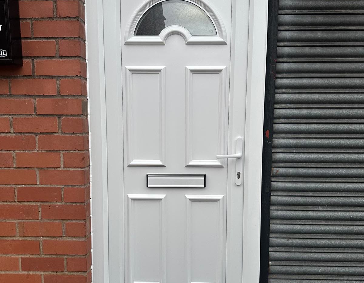 A white uPVC panel front door with an arched top light and chrome letterplate, fitted by URG